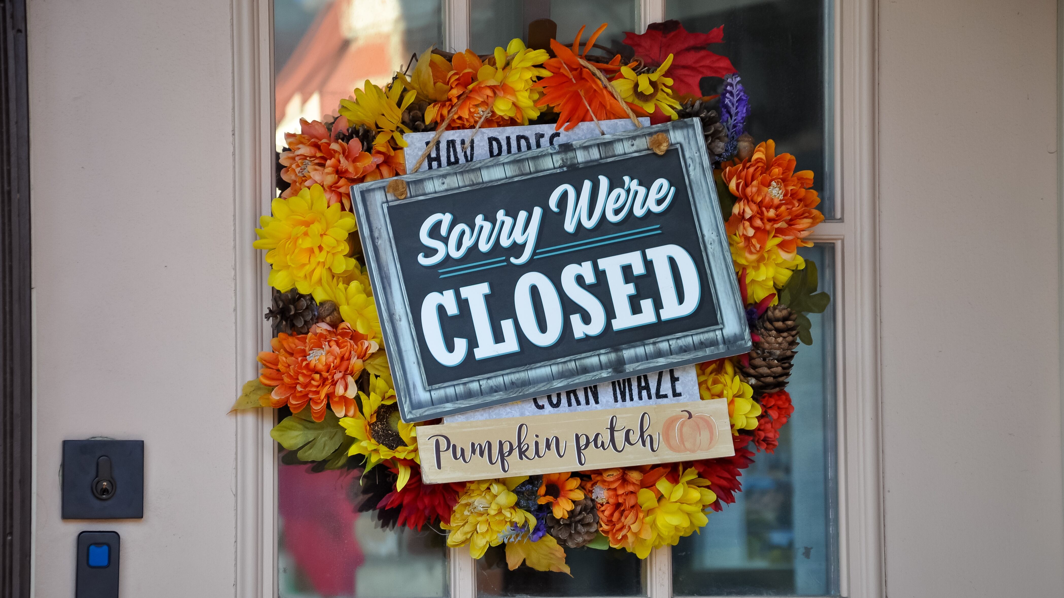 Sign reading sorry we're closed with a fall theme