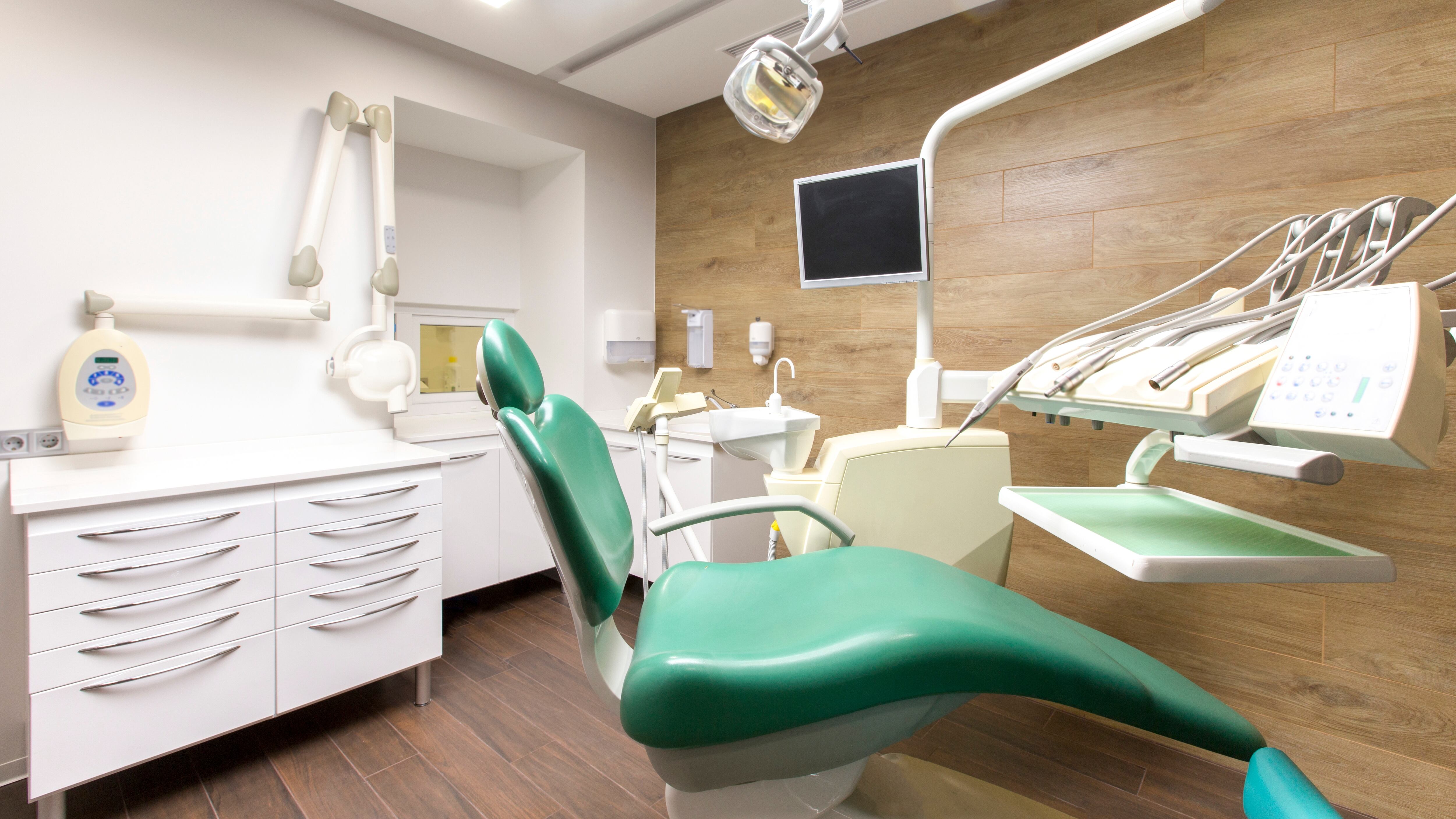 Dentist tools and a professional children's dentistry chair waiting to be used by an orthodontist, modern interior, no people
