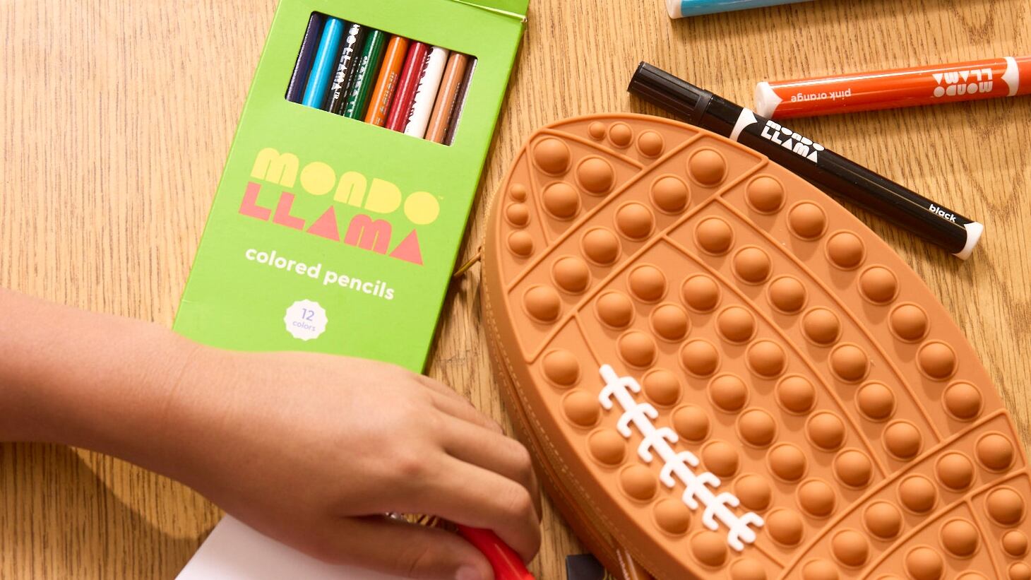 A child using school supplies to draw.